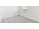 Empty bedroom featuring neutral carpet, white walls, and a window with blinds at 3054 Suraj Cir, Tavares, FL 32778