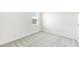 Neutral bedroom featuring carpeted floors and natural light from a large window at 3054 Suraj Cir, Tavares, FL 32778