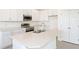 Well-lit kitchen showcasing white cabinets, stainless steel appliances, and an island with double sink at 3054 Suraj Cir, Tavares, FL 32778
