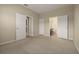 Spacious bedroom with neutral carpet and multiple doorways to bathroom and closets at 889 Park Grove Ct, Orlando, FL 32828