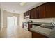 Kitchen featuring stainless steel appliances, tiled flooring, and stylish cabinetry at 889 Park Grove Ct, Orlando, FL 32828
