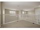 Carpeted loft area with white railing, lighting, and windows creating an inviting and versatile space at 889 Park Grove Ct, Orlando, FL 32828