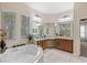 Bathroom with a large vanity, soaking tub and shower at 25515 Hawks Run Ln, Sorrento, FL 32776