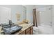 Bathroom with granite countertop, dark sink, and shower/tub combo at 25515 Hawks Run Ln, Sorrento, FL 32776