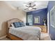 Guest bedroom with a wooden bed frame and blue accent wall at 25515 Hawks Run Ln, Sorrento, FL 32776