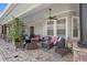Relaxing covered patio with comfortable seating and ceiling fan at 25515 Hawks Run Ln, Sorrento, FL 32776