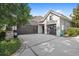 Two-car garage with dark brown doors and a large concrete driveway at 25515 Hawks Run Ln, Sorrento, FL 32776