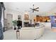 Open Gathering room with curved sectional sofa and view to kitchen at 25515 Hawks Run Ln, Sorrento, FL 32776
