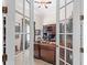 Bright home office features built-in shelving and French doors at 25515 Hawks Run Ln, Sorrento, FL 32776