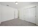 This bedroom features neutral carpet, a double-door closet, and fresh paint, providing a cozy space at 4929 Kaia Ave, Winter Haven, FL 33884