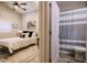 Charming bedroom adjacent to bathroom, with neutral decor, and a tranquil ambiance at 4600 Nebraska Ave, Sanford, FL 32771