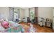 Bright bedroom features terra cotta tile, natural light, and a comfortable bed, creating a cozy and inviting space at 4600 Nebraska Ave, Sanford, FL 32771