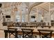 Large event space featuring wooden tables and chairs beneath elegant chandeliers at 4600 Nebraska Ave, Sanford, FL 32771