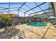 Relaxing screened-in pool area with stone patio and outdoor furniture, perfect for entertaining at 4600 Nebraska Ave, Sanford, FL 32771