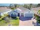 Aerial view of a beautiful single-Gathering home with well-maintained landscaping and brick-paved driveway at 840 Jasmine Creek Rd, Kissimmee, FL 34759