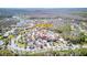 Aerial view of The Palms community, featuring a clubhouse, pool, and surrounding homes in a lush landscape at 840 Jasmine Creek Rd, Kissimmee, FL 34759