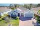 Aerial view of a house in a residential community with a lake at 840 Jasmine Creek Rd, Kissimmee, FL 34759