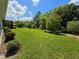 Expansive backyard featuring lush green lawn and a variety of trees and shrubbery for maximum privacy at 840 Jasmine Creek Rd, Kissimmee, FL 34759