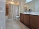 Bright bathroom featuring a shower-tub combo with curtain, tile flooring, and vanity with mirror at 840 Jasmine Creek Rd, Kissimmee, FL 34759