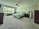 The main bedroom boasts a ceiling fan, large windows, and neutral carpeting at 840 Jasmine Creek Rd, Kissimmee, FL 34759
