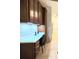 A built-in desk with storage features dark wood cabinets, drawers, lighting and white backsplash for an efficient workspace at 840 Jasmine Creek Rd, Kissimmee, FL 34759
