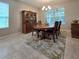 This dining room features an elegant wooden table, decorative rug, and a hutch for stylish storage at 840 Jasmine Creek Rd, Kissimmee, FL 34759