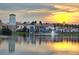 Beautiful exterior of the property at sunset with a pond and fountain at 840 Jasmine Creek Rd, Kissimmee, FL 34759