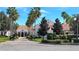 Beautiful building with manicured landscaping, stately palm trees, and a paver drive offers curb appeal at 840 Jasmine Creek Rd, Kissimmee, FL 34759