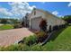 Charming single-story home featuring a two-car garage and a brick-paved driveway with colorful landscaping at 840 Jasmine Creek Rd, Kissimmee, FL 34759