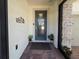 Welcoming front entryway with glass-paneled door, brick pathway and decorative welcome sign at 840 Jasmine Creek Rd, Kissimmee, FL 34759