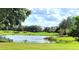 Scenic view of a well-manicured golf course with a pond at 840 Jasmine Creek Rd, Kissimmee, FL 34759