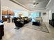 Open-concept living area with tile flooring, ceiling fan, and modern furniture at 840 Jasmine Creek Rd, Kissimmee, FL 34759