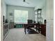 This home office is complete with a desk, bookcase, chair, and bright, natural lighting at 840 Jasmine Creek Rd, Kissimmee, FL 34759