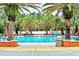 Resort-style pool area featuring palm trees, lounge chairs, and paved decking for relaxation at 840 Jasmine Creek Rd, Kissimmee, FL 34759