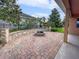 Paver patio features a charming fire pit and leads to the lush backyard at 3125 Winesap Way, Winter Garden, FL 34787