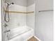 Standard bathroom features a shower-tub combo, white tile, and chrome fixtures at 3125 Winesap Way, Winter Garden, FL 34787