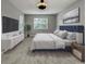Comfortable bedroom features a plush bed, natural light, and sleek, modern decor at 3125 Winesap Way, Winter Garden, FL 34787