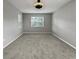 Bright, carpeted bedroom with abundant natural light and ceiling fan at 3125 Winesap Way, Winter Garden, FL 34787