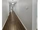 Long hallway with wood flooring and neutral-toned walls, offering ample space and natural light at 3125 Winesap Way, Winter Garden, FL 34787