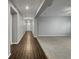 Inviting hallway with wood-look floors leading to the front door and carpeted living area at 3125 Winesap Way, Winter Garden, FL 34787
