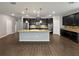 Spacious kitchen boasts a large island, stainless steel appliances, and dark cabinets at 3125 Winesap Way, Winter Garden, FL 34787