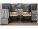 This kitchen features stainless steel appliances and dark cabinetry with mosaic backsplash at 3125 Winesap Way, Winter Garden, FL 34787