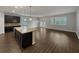 Open concept kitchen and living room with island sink and stainless steel dishwasher at 3125 Winesap Way, Winter Garden, FL 34787
