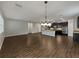 Open-concept living space with hardwood floors, neutral walls and kitchen with stainless steel appliances at 3125 Winesap Way, Winter Garden, FL 34787