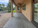 Covered patio with ceiling fan, offering a view of the brick paver patio and landscaping at 3125 Winesap Way, Winter Garden, FL 34787