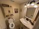 Charming bathroom with a pedestal sink, toilet and decorative wall art at 9524 Bay Vista Estates Blvd, Orlando, FL 32836