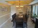 Elegant dining room with a large table and chandelier at 9524 Bay Vista Estates Blvd, Orlando, FL 32836