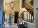 Elegant entryway featuring a chandelier and a grandfather clock at 9524 Bay Vista Estates Blvd, Orlando, FL 32836