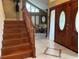 Grand entryway with tiled floors, wooden staircase, and double doors at 9524 Bay Vista Estates Blvd, Orlando, FL 32836