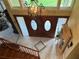 View of entryway from upstairs, showcasing staircase and double doors at 9524 Bay Vista Estates Blvd, Orlando, FL 32836